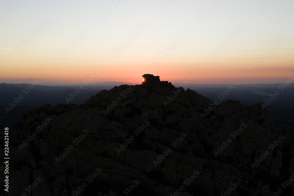 Aerial view of a spectacular sunset behind some rocky mountains in Sardinia, Italy. Aerial view of a spectacular sunset behind some rocky mountains in Sardinia, Italy.