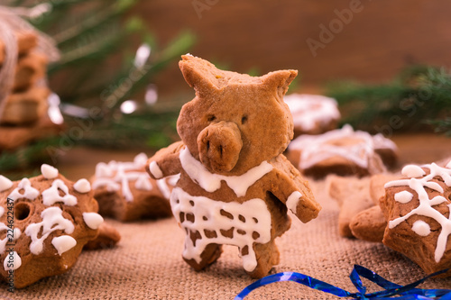 The figure of a Piglet of baked dough, decorated with icing sugar, decoration for the festive table in the year of the pig.