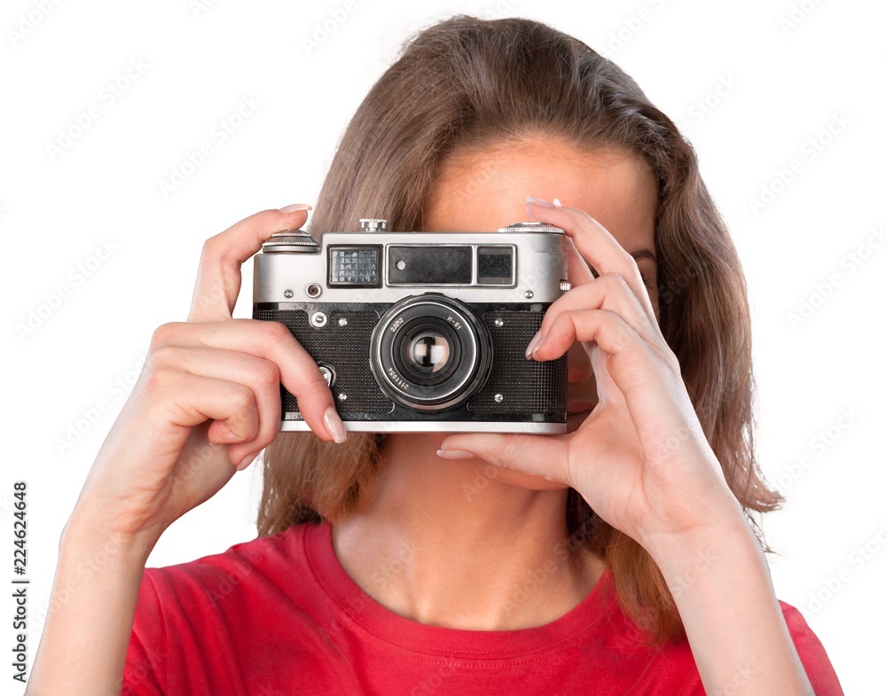 Pretty young woman holding camera isolated on white background Pretty young woman holding camera isolated on white background