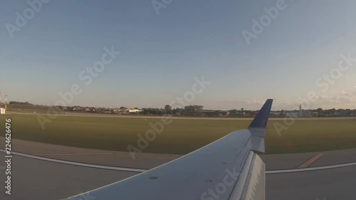 Jet landing at O'hare from a passenger over the wing photo