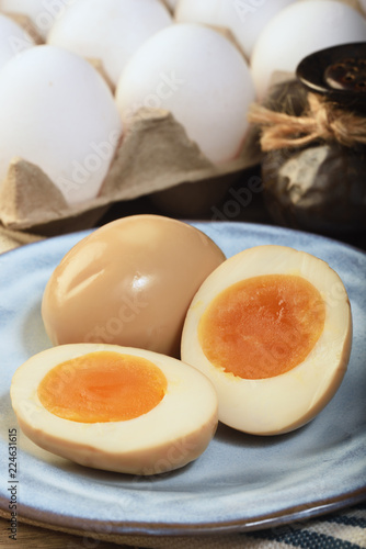 Plate of soft boiled eggs on wooden table