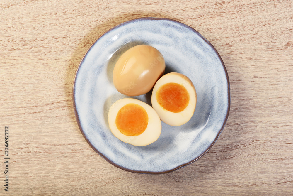 Plate of soft boiled eggs on wooden table Plate of soft boiled eggs on wooden table
