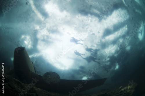 Winter ice diving underwater in a quarry in Canada