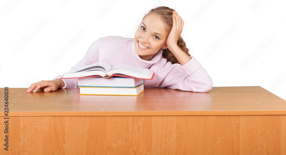 Friendly Young Girl Sitting Behind a Desk with a Books - Friendly Young Girl Sitting Behind a Desk with a Books -