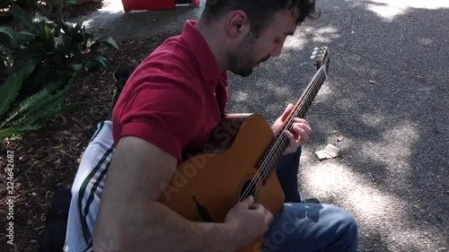 Guitarrist Musician busking in the park