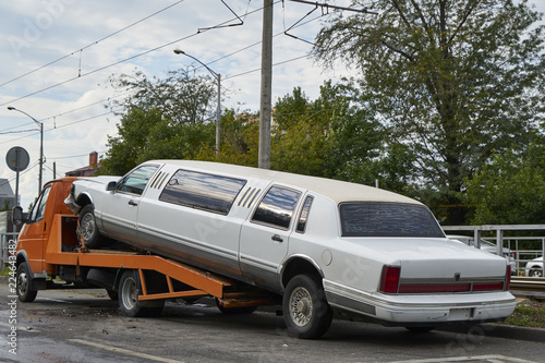 The image of the limousine on the tow truck.