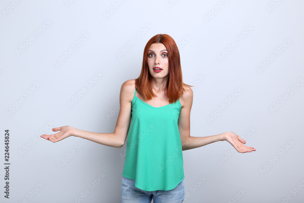 Beautiful redhaired woman on grey background Beautiful redhaired woman on grey background