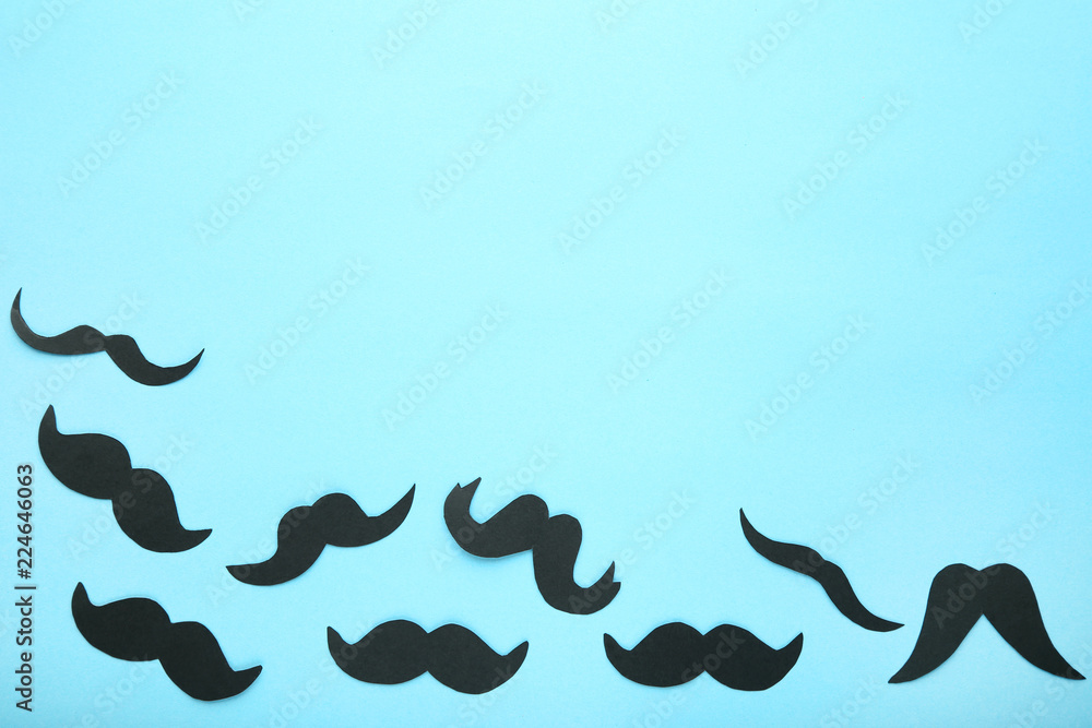 Black paper mustache on blue background Black paper mustache on blue background