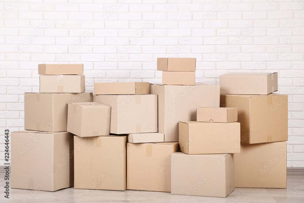 Cardboard boxes on brick wall background Cardboard boxes on brick wall background
