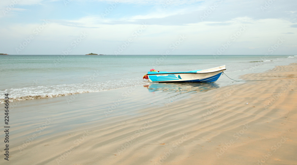 Nilaveli beach with beached fishing boat in Sri Lanka Asia