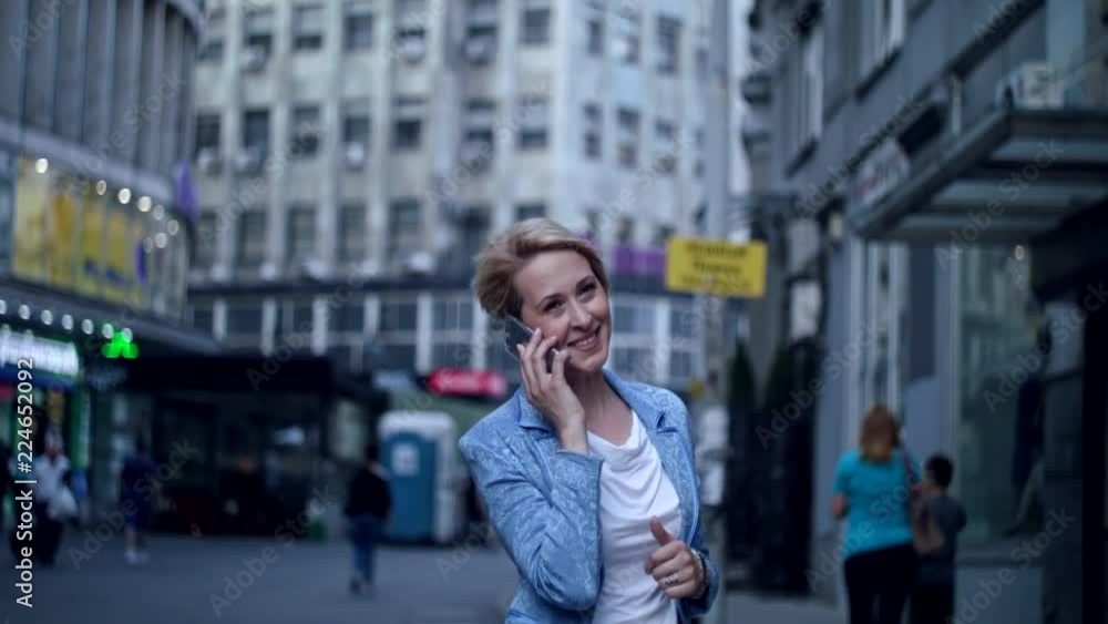 Beautiful business woman receives a call on the street Beautiful business woman receives a call on the street