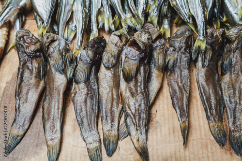 Several dried fish gobies lie on counter photo