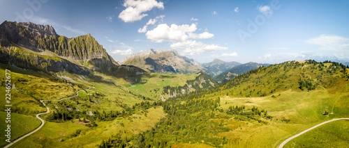 Panoramic aerial view of the moutains in the Col des Aravis in the French alps on a sunny day © Nicolas Faramaz