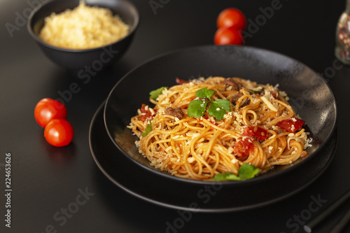 Delicious spaghetti with Bolognese sauce served on a black plate