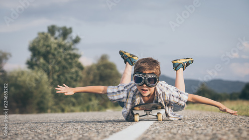 Happy little boy playing on the road at the day time.