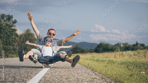 Father and son playing on the road at the day time.