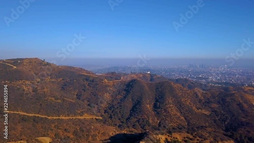 Aerial view on the Hollywood sign district with private houses and road leading to Griffin park.