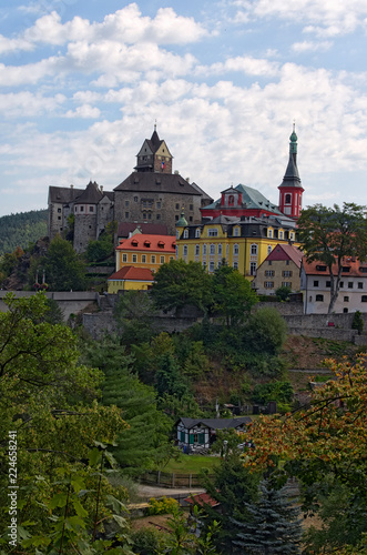 Scenic landscape view of medieval Loket Castle with colorful buildings by summer sunny day. Bohemia, Sokolov, Karlovarsky Region, Czech Republic