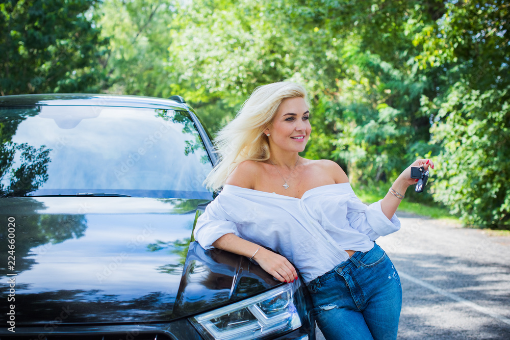 Woman sitting at car and nature on background, road trip concept. Lady and  her car, stories from life. Lifestyle modern woman Stock Photo | Adobe Stock
