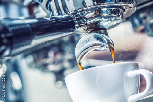 Close-up coffee machine pouring hot espresso.