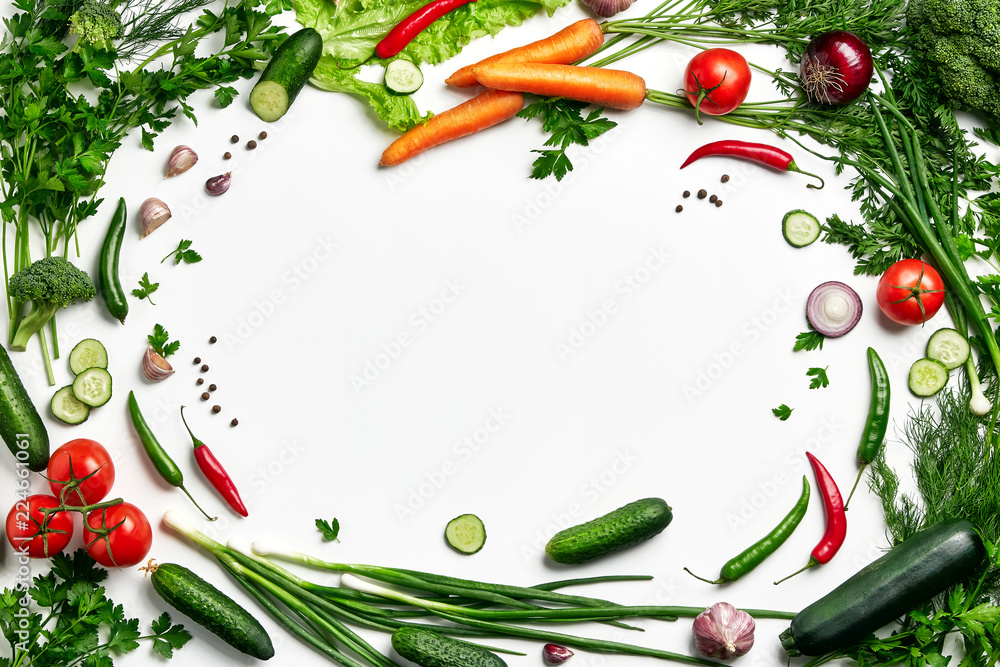 Frame of vegetables with a free zone in the center. A set of vegetables, tomatoes, zucchini, broccoli, carrots, parsley, onions, cucumber. Fresh natural vegetables.