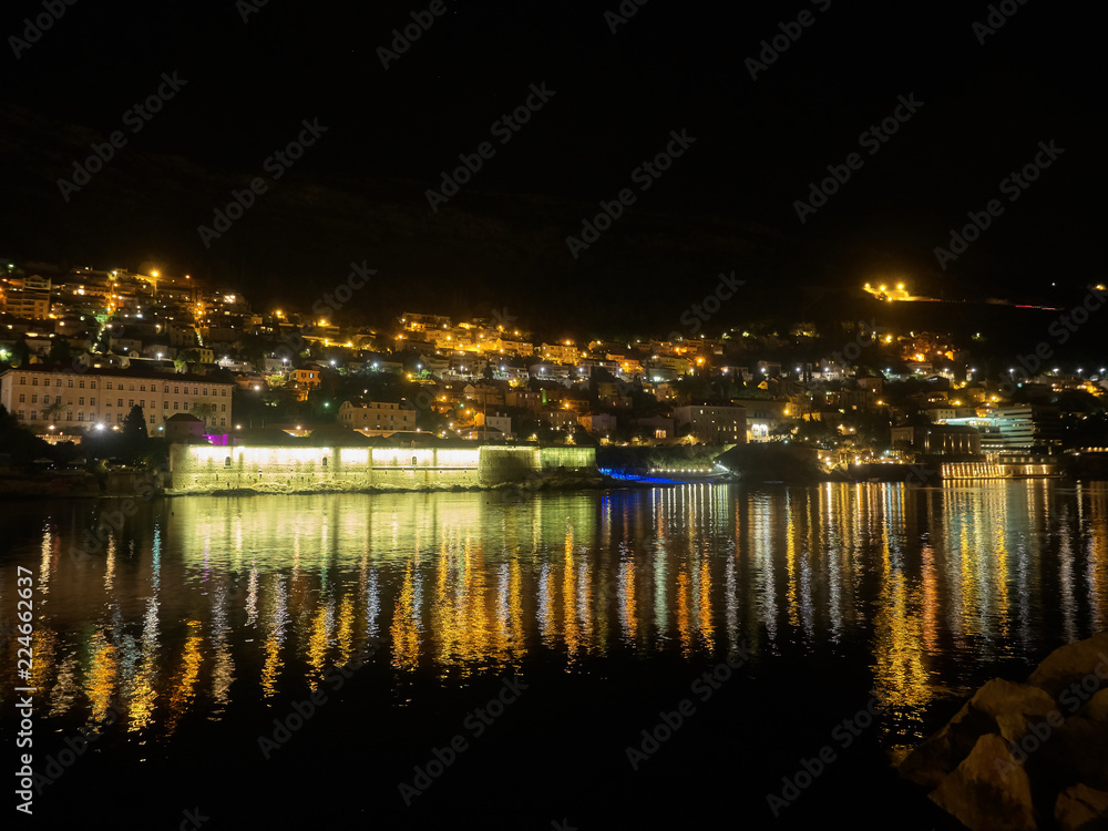 Dubrovnik city lights reflecting into water