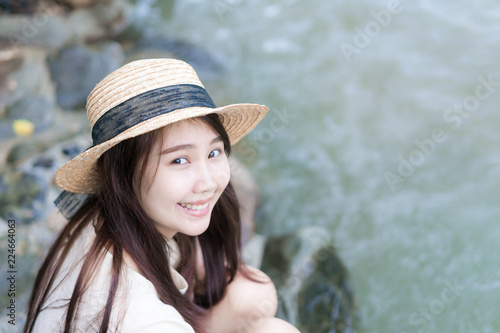 teen girl sitting near waterfall