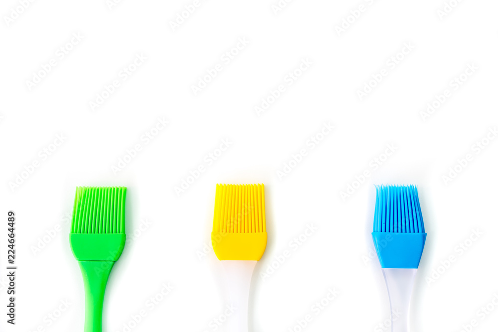 Colorful Silicone brush with copy space on white background, Top view Colorful Silicone brush with copy space on white background, Top view