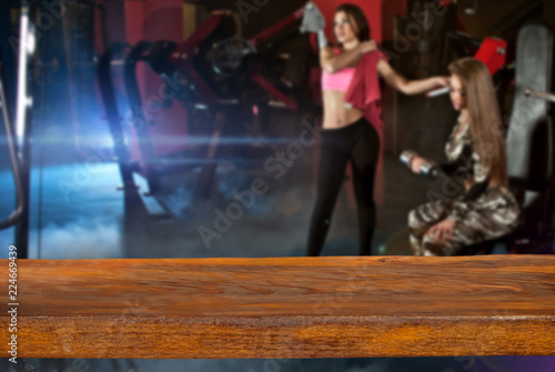 A wooden board in the foreground and a gym in the background.