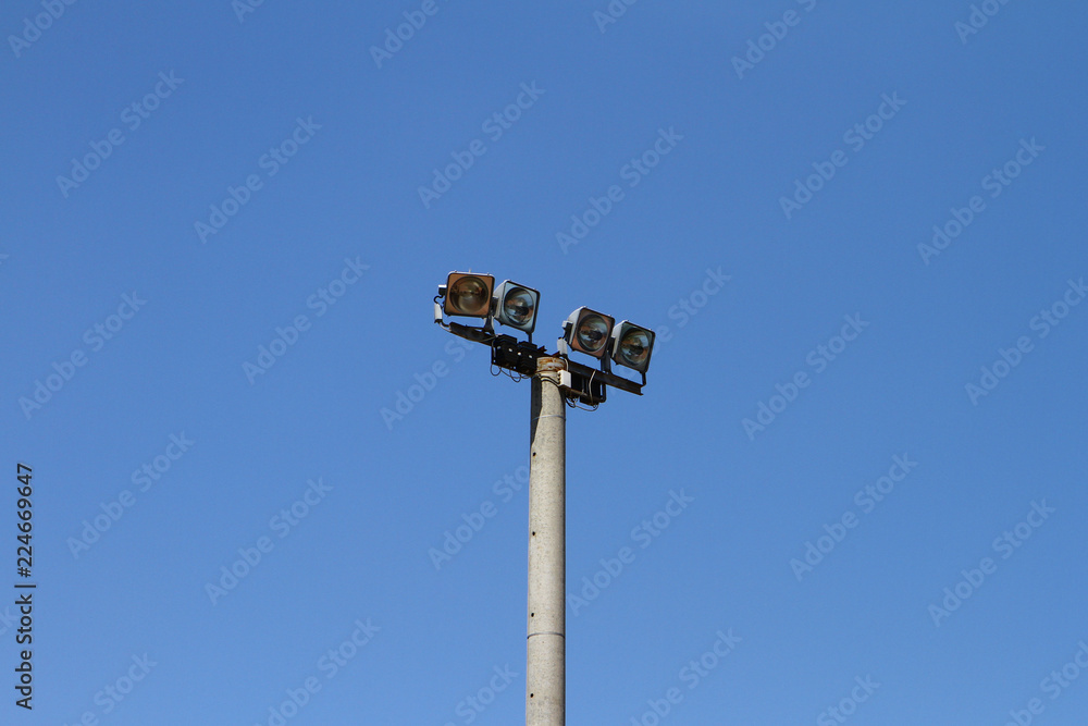 Big grey concrete lighting pole on a blue sky background, objects photo Big grey concrete lighting pole on a blue sky background, objects photo