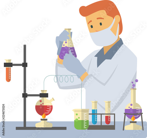 young male chemist measuring chemical liquid with test tubes and flasks