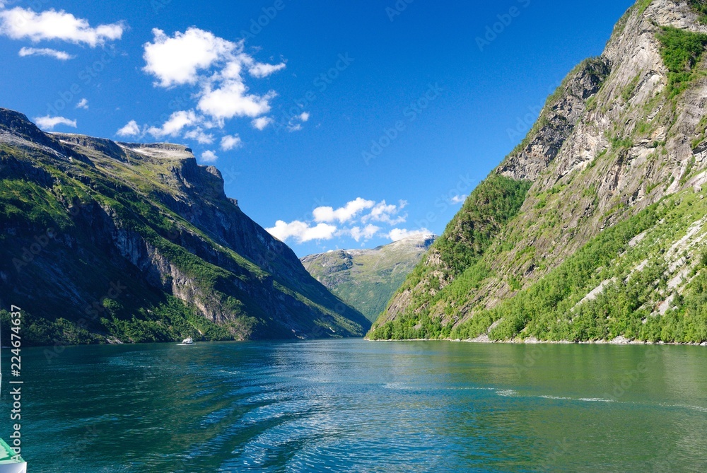 View of nearby mountains and waterfalls from the Geirangerfjord in Norway View of nearby mountains and waterfalls from the Geirangerfjord in Norway