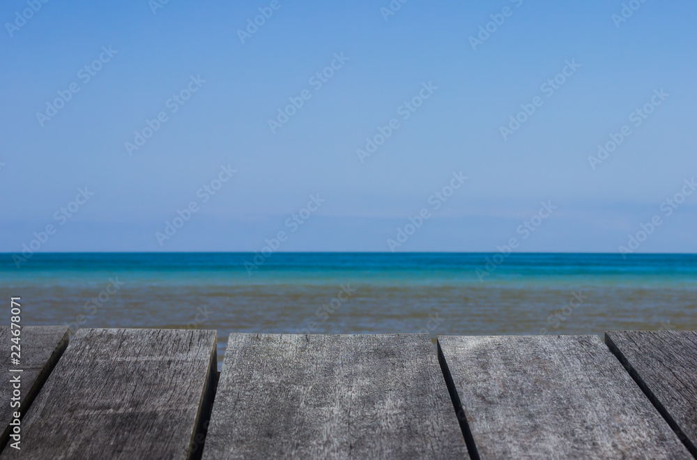 perspective old wooden floor texture and blue sea background.