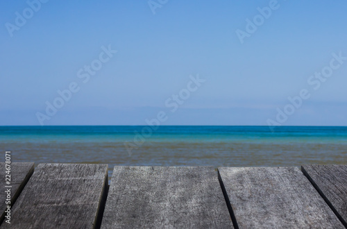 perspective old wooden floor texture and blue sea background.