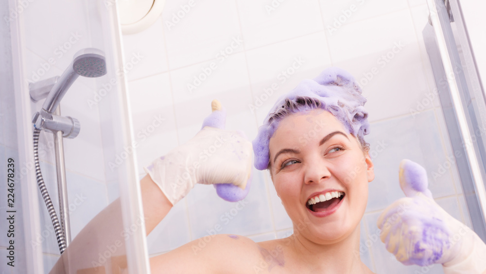 Woman applying toner shampoo on her hair Woman applying toner shampoo on her hair