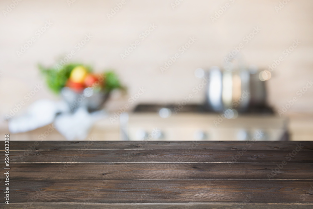 Blurred background. Modern kitchen with empty wooden tabletop and space for you.