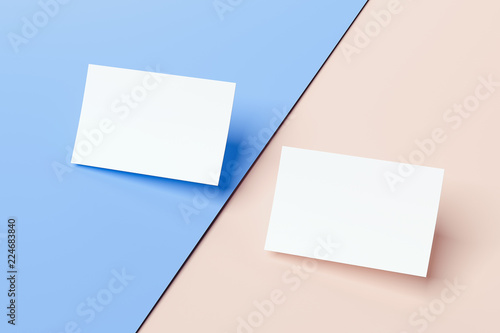 Close up of white business cards set on multicolored background, 3d rendering. © ekostsov