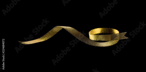 Golden ribbon isolated on black background and texture, with clipping path
