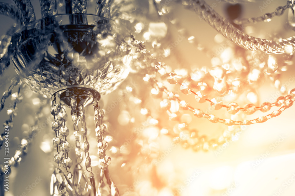 abstract image background of blur bokeh and crystal chandelier light equipment filter tone color effect