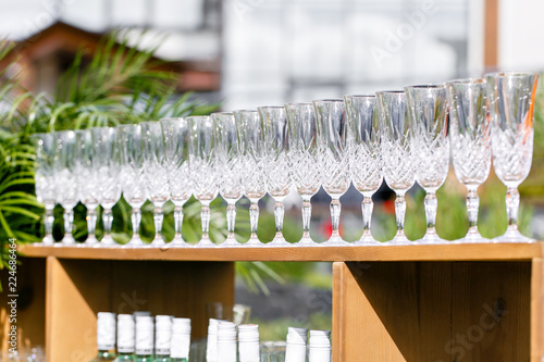 glasses on wooden table. Catering set-up ready for the event to begin. ervice area the waiter in restaurant. photo