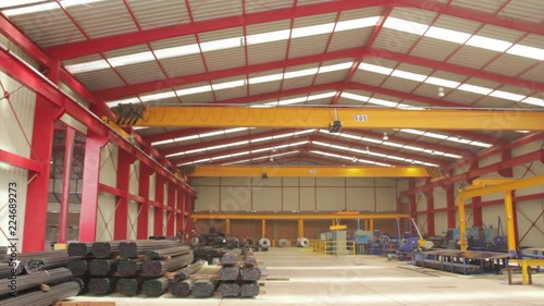 Overhead cranes in a steel warehouse photo