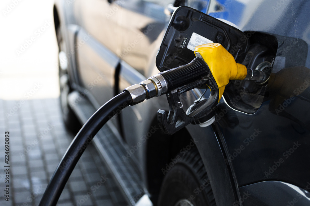 gun at the gas station is inserted into the tank of the car gun at the gas station is inserted into the tank of the car