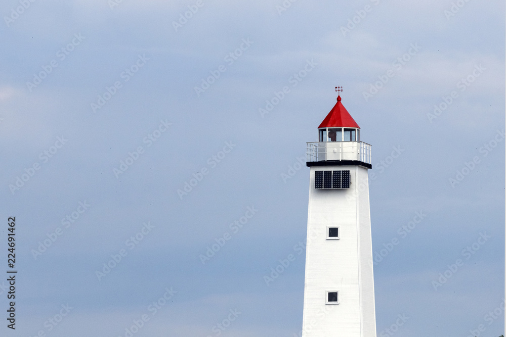 White lighthouse against blue sky