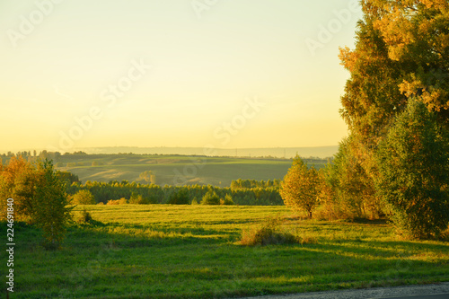Autumn countryside in the evening in the rays of the setting sun.