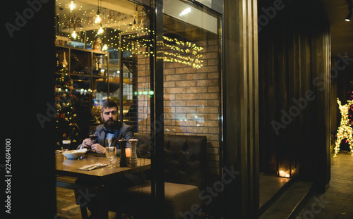 Bearded man rest in restaurant with wine glass. Bearded man wait in bar and drink wine. © Volodymyr