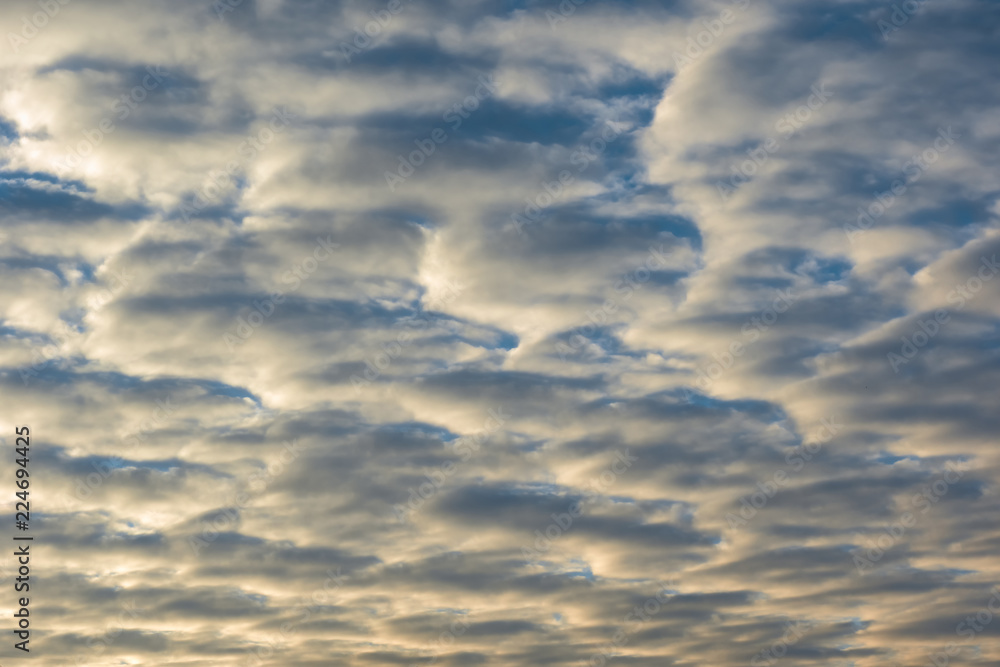Horizontal background with sunlitted clouds