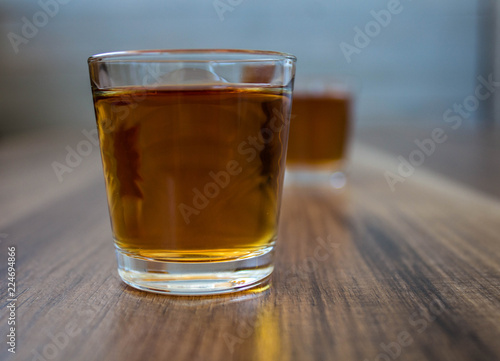 a two piles of whiskey on a wooden background