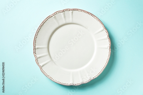 White plate on blue background, from above