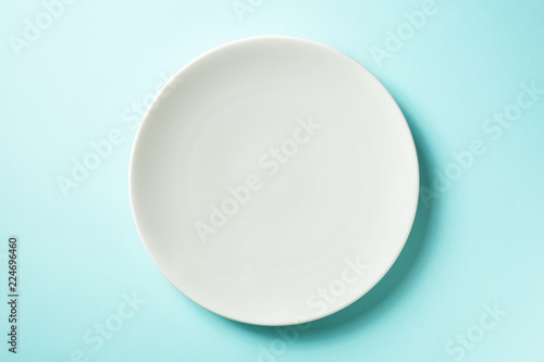 White plate on blue background, from above