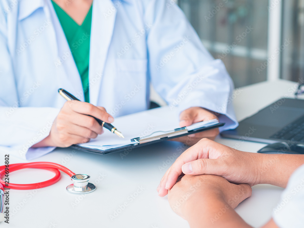 Doctor and Patient are talking in the hospital. Health care and Medical Concept. Doctor and Patient are talking in the hospital. Health care and Medical Concept.